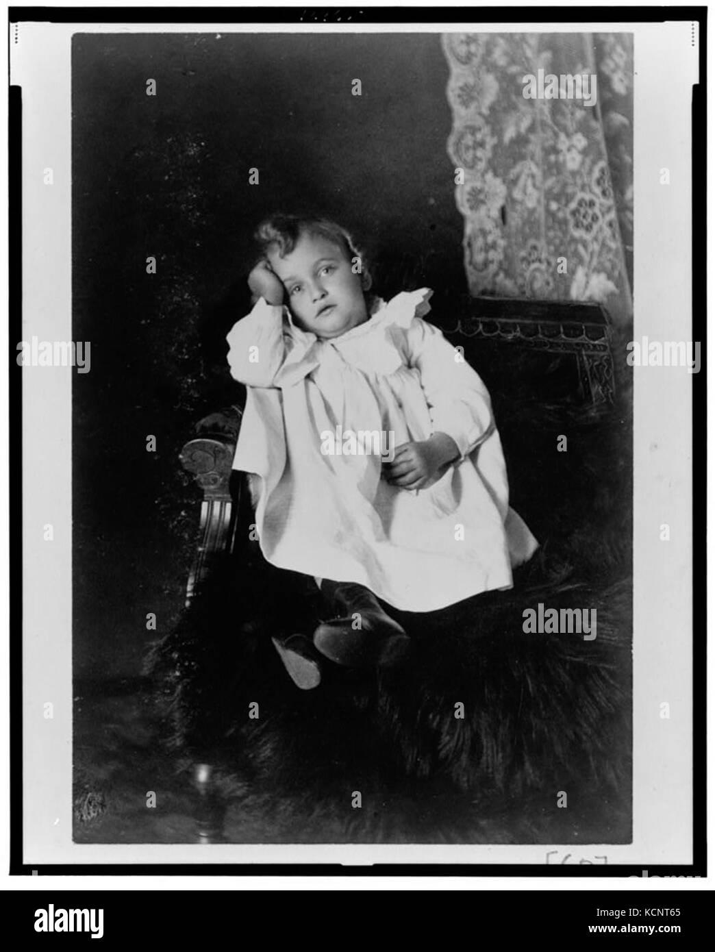 African American girl, full length portrait, seated in chair, head resting on right hand, facing front LCCN99472097 Stock Photo