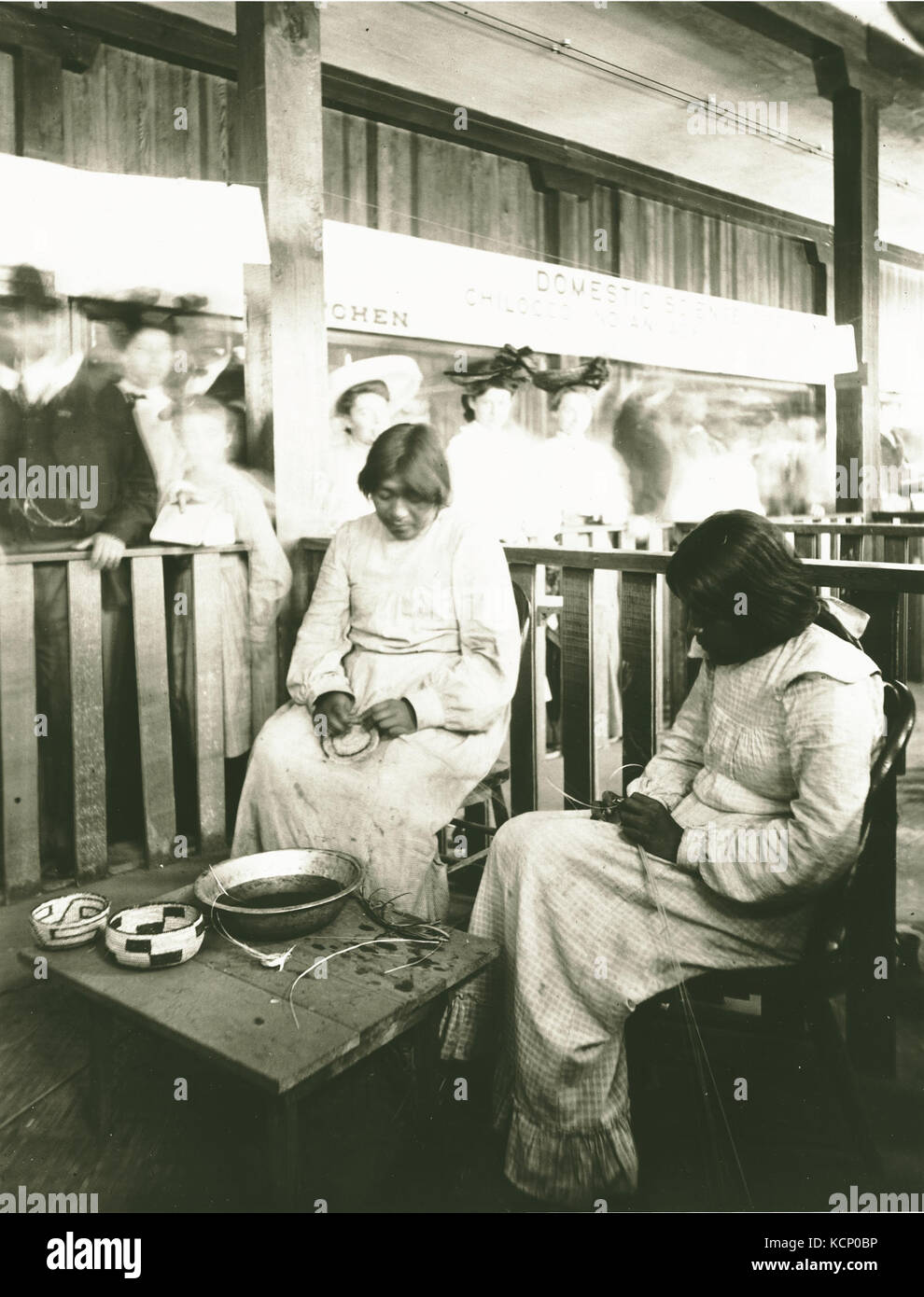 Effa Rhodes and Amy Enos, of the O'odham (Pima tribe) weaving baskets in  the Domestic Science exhibit at the Model Indian School. Department of  Anthropology, 1904 World's Fair Stock Photo - Alamy