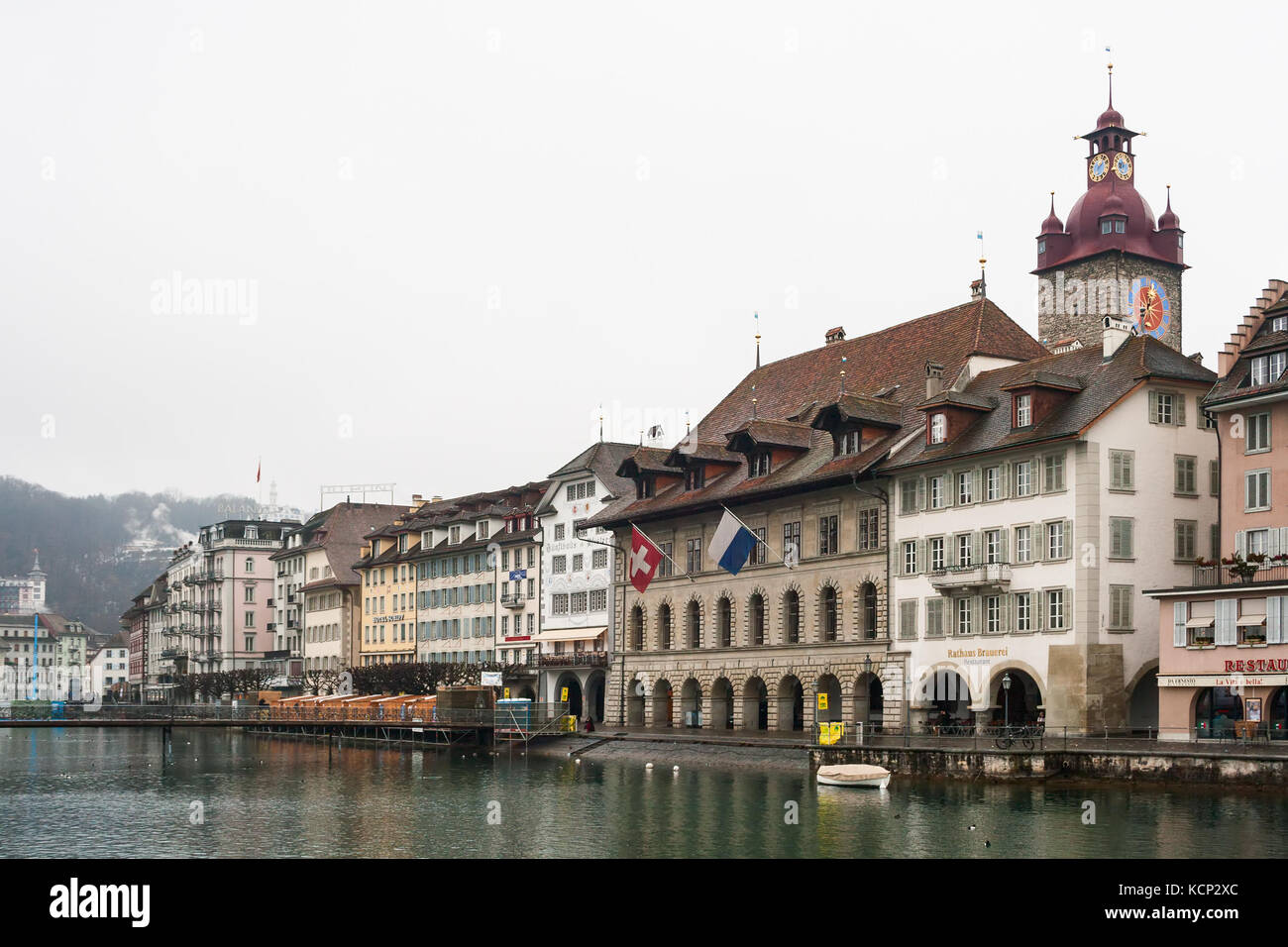 LUCERNE, SWITZERLAND - FEBRUARY 04, 2010: Lucerne in winter. Fog, rain and bad weather. View of the Rathausquai and the Clock Tower Stock Photo
