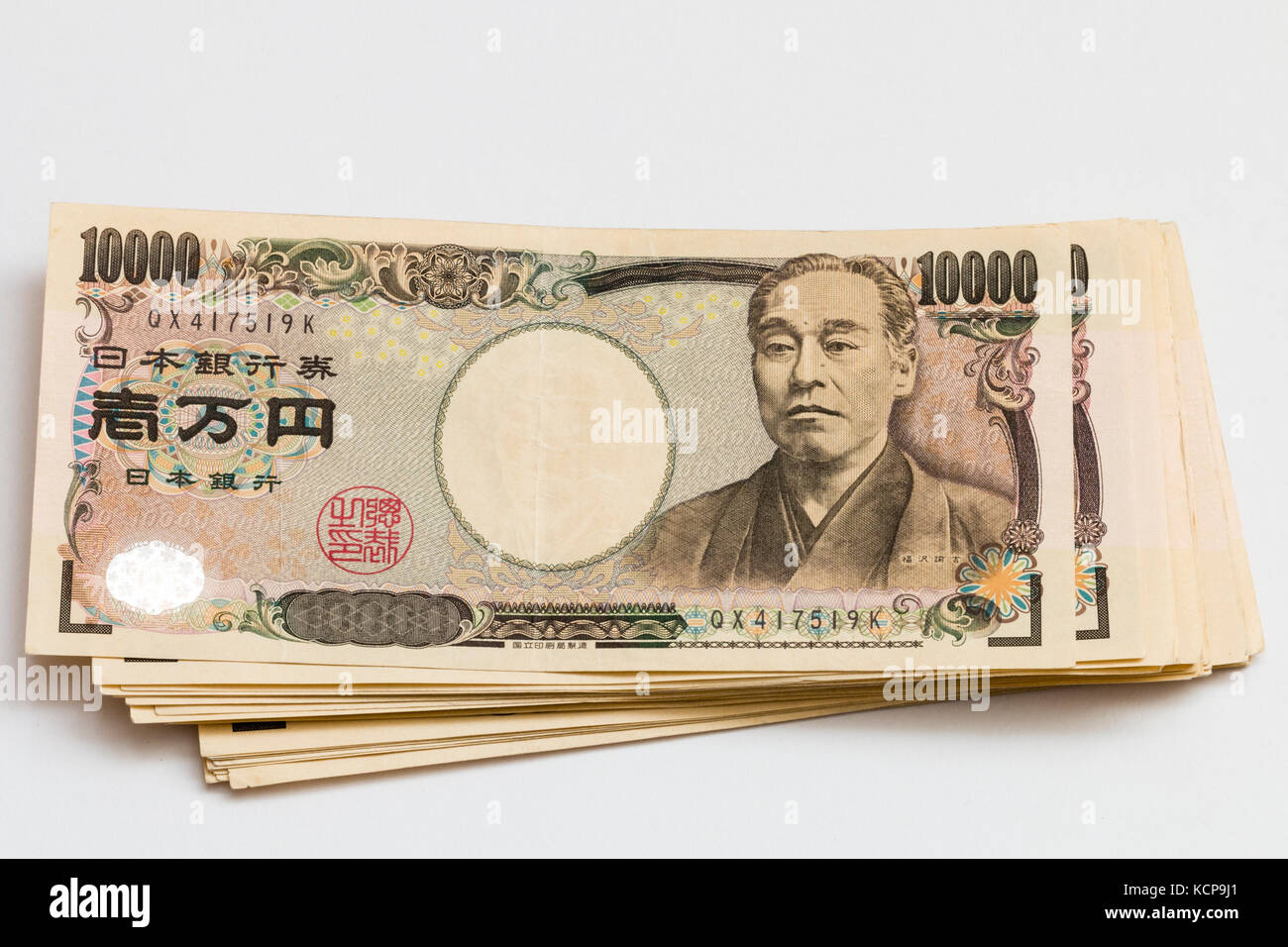 Japanese banknotes. Pile of 10,000 Yen notes on white background. Stock Photo