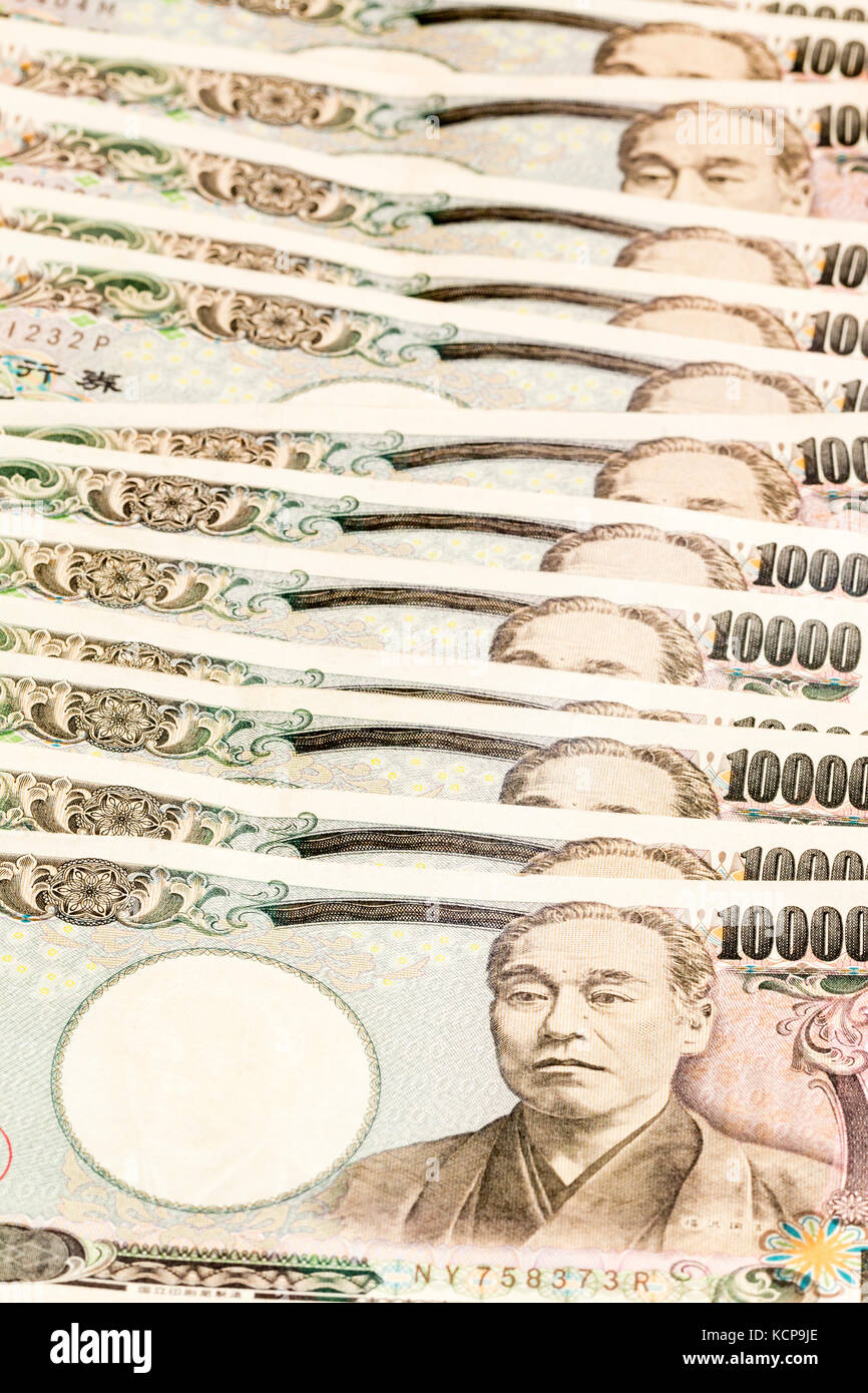 Japanese banknotes. Line of overlapping 10,000 Yen notes on white background. Stock Photo
