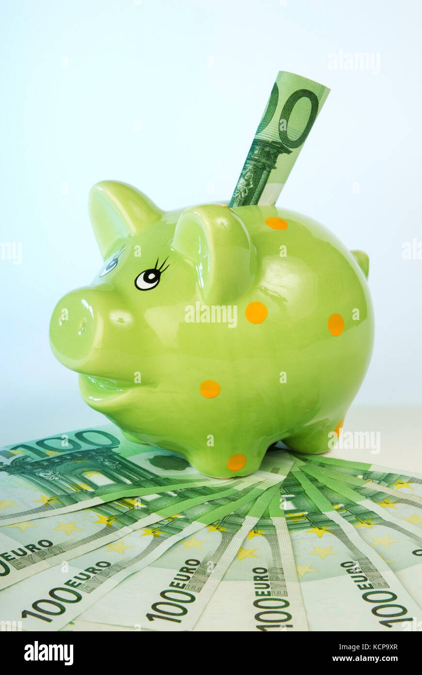 Green piggy bank with banknotes Stock Photo