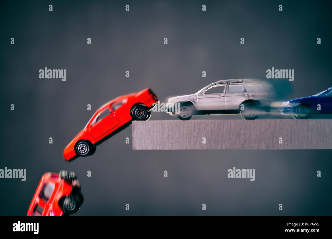 Cars drive to an abyss and crash Stock Photo