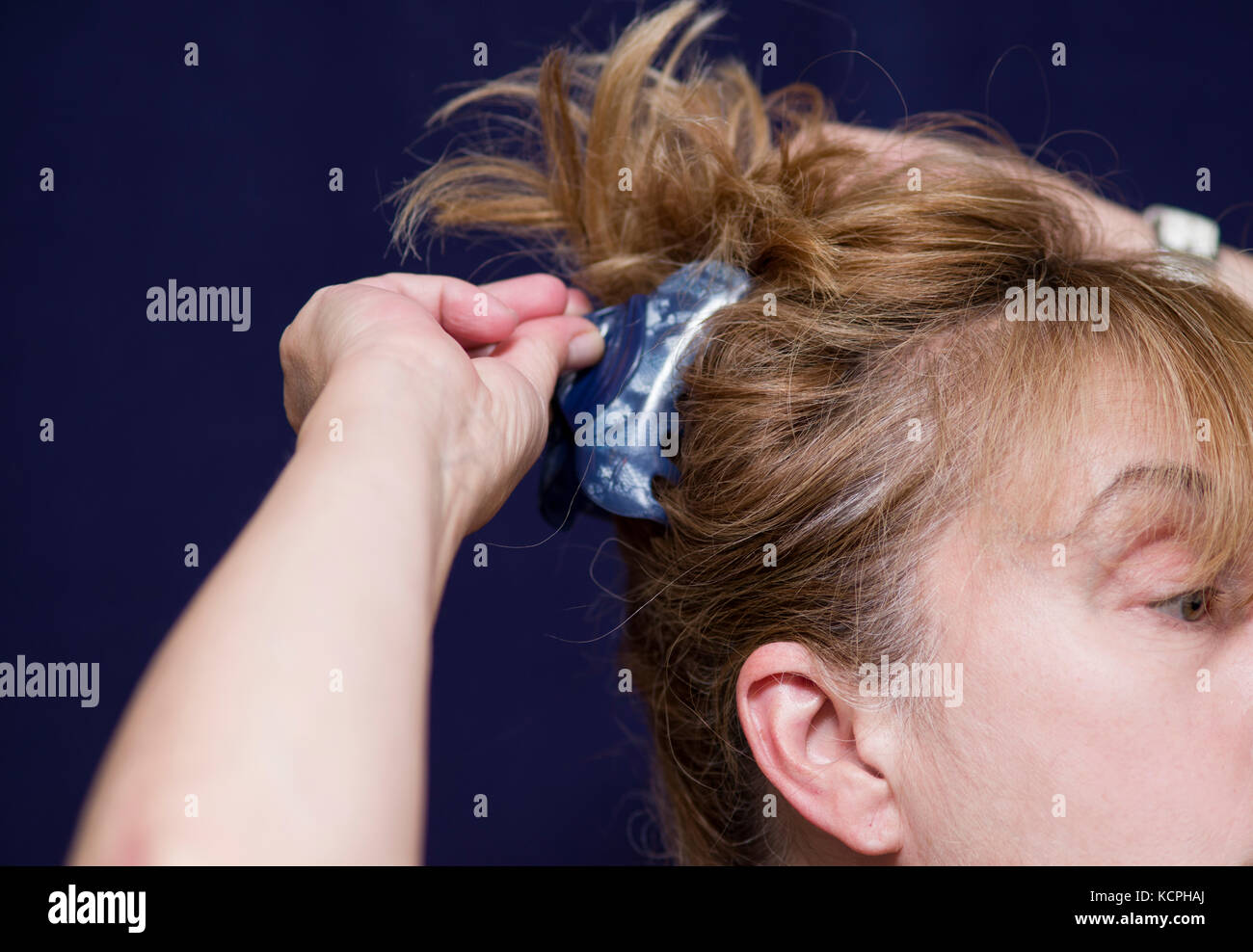 Woman arranging her hair hi-res stock photography and images - Alamy