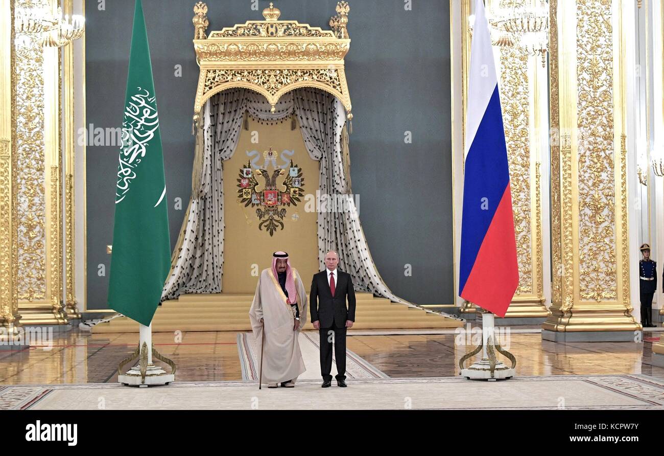 King Salman bin Abdulaziz Al Saud of Saudi Arabia stands with Russian President Vladimir Putin