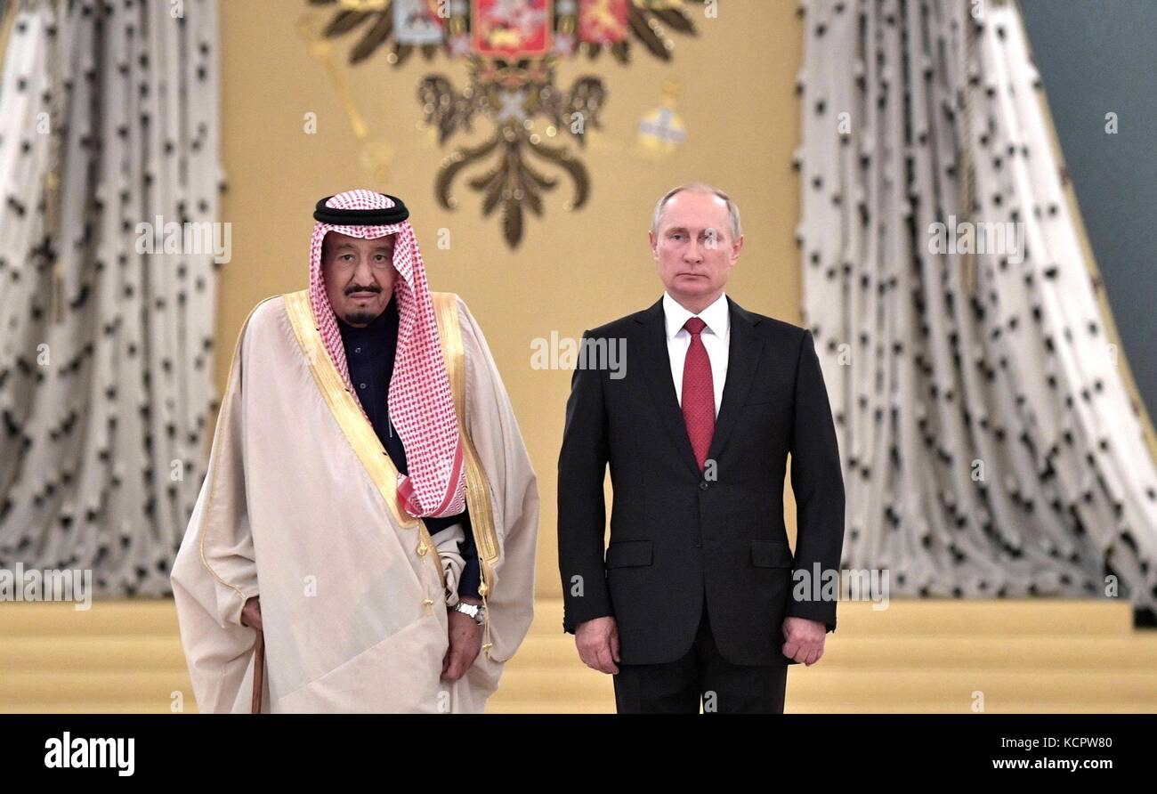 King Salman bin Abdulaziz Al Saud of Saudi Arabia stands with Russian President Vladimir Putin