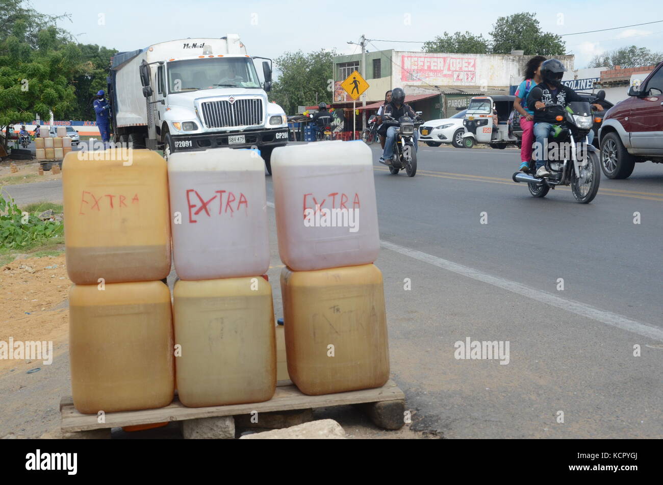 Canisters full of smuggled oil can be seen on sale in the border city