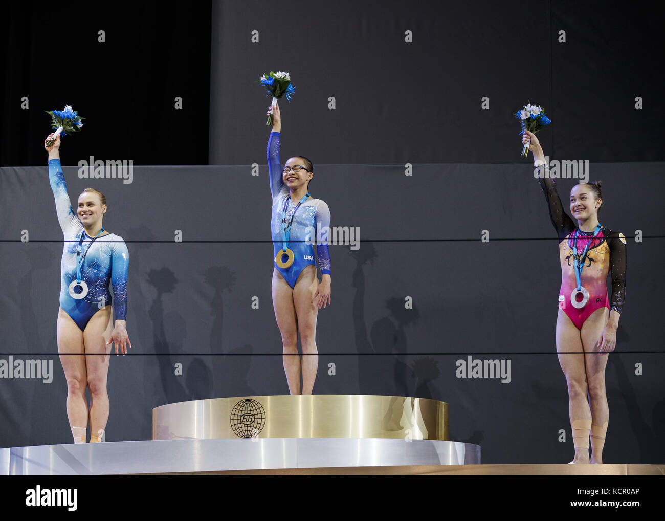 Russian gymnast stands on the podium with symbol supporting