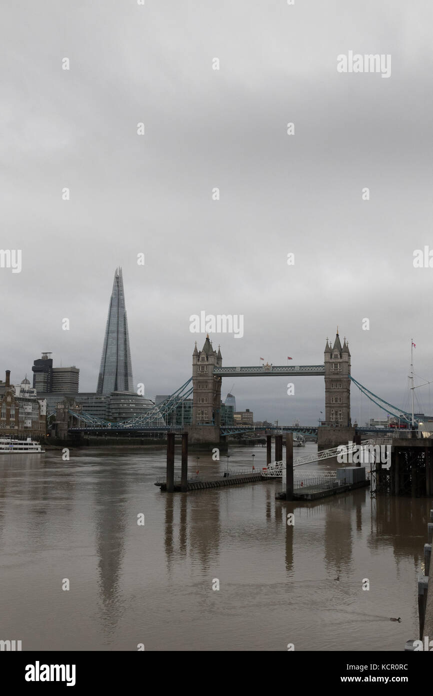 London, UK. 7th Oct, 2017. Grey cloudy sky is seen behind Tower Bridge and the Shard on the River Thames in London this morning. Credit: Vickie Flores/Alamy Live News Stock Photo