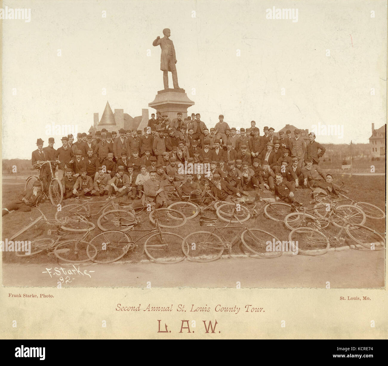 Bicyclists of the League of American Wheelmen pose by the Frank Blair