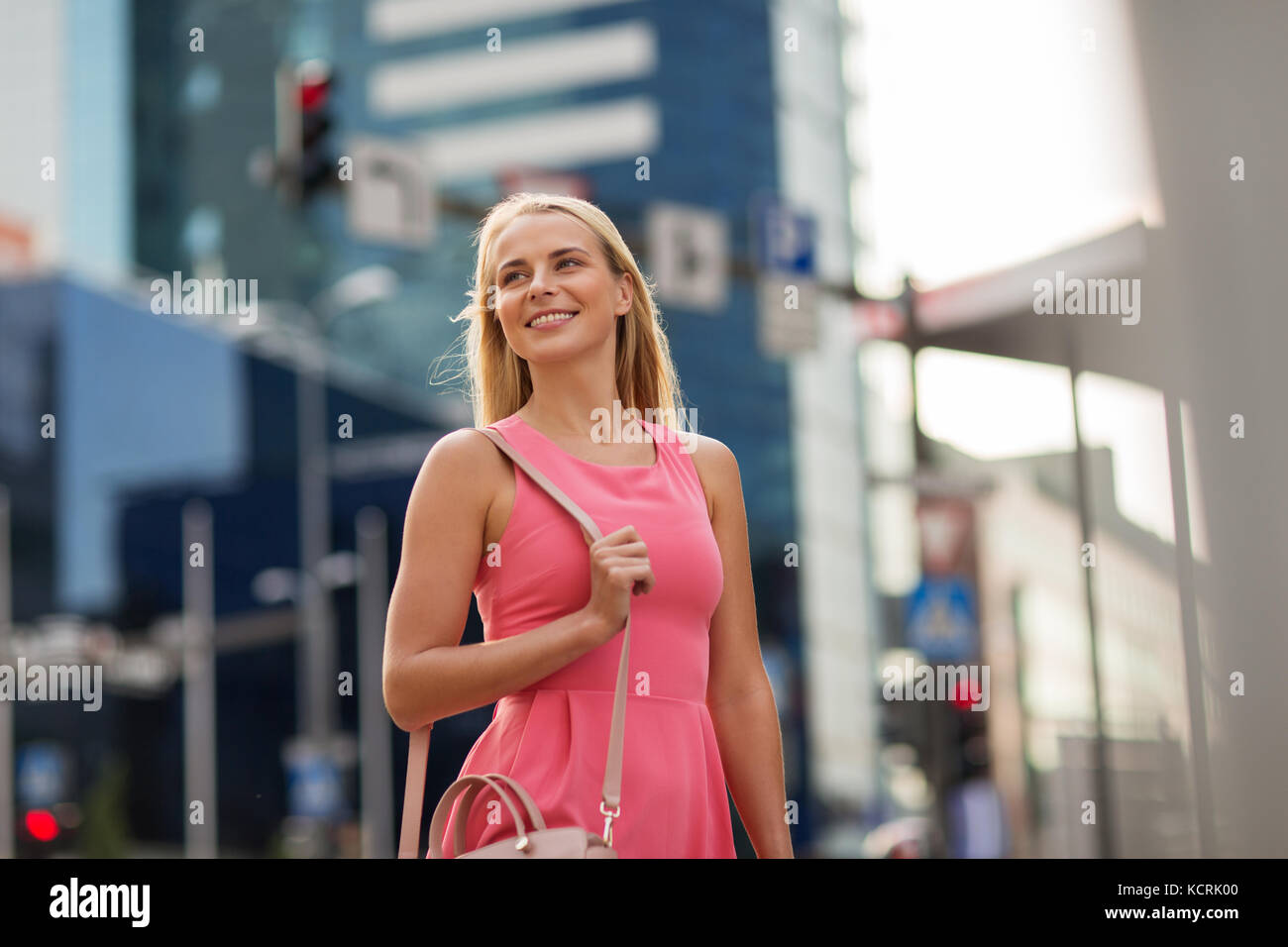 happy smiling young woman on city street Stock Photo - Alamy