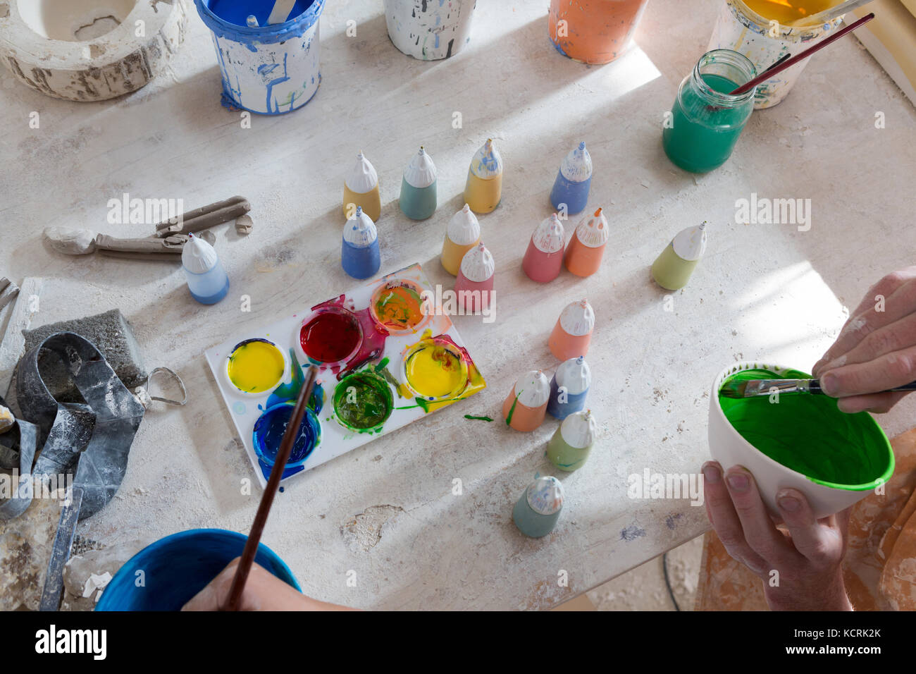 Hands of male potter and girl painting bowl in pottery workshop Stock ...