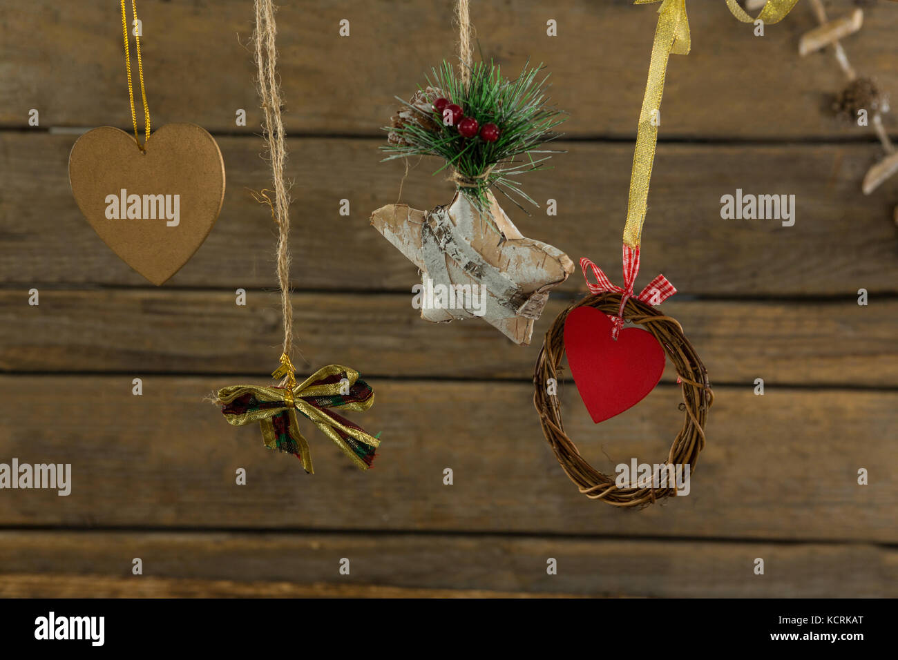 High angle view of Christmas decorations with thread against wooden table Stock Photo