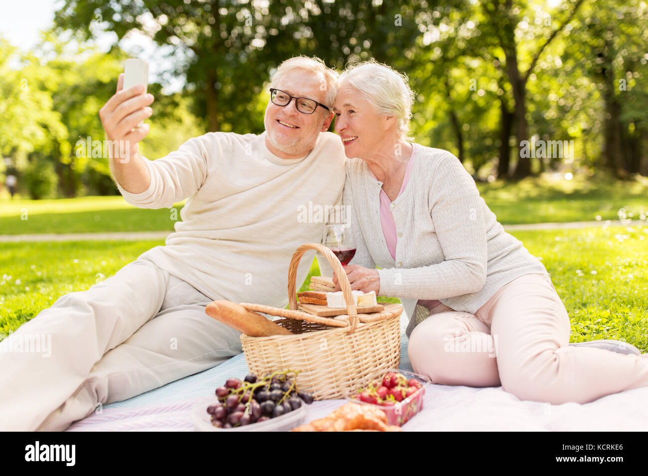 senior couple taking selfie at picnic in park Stock Photo - Alamy