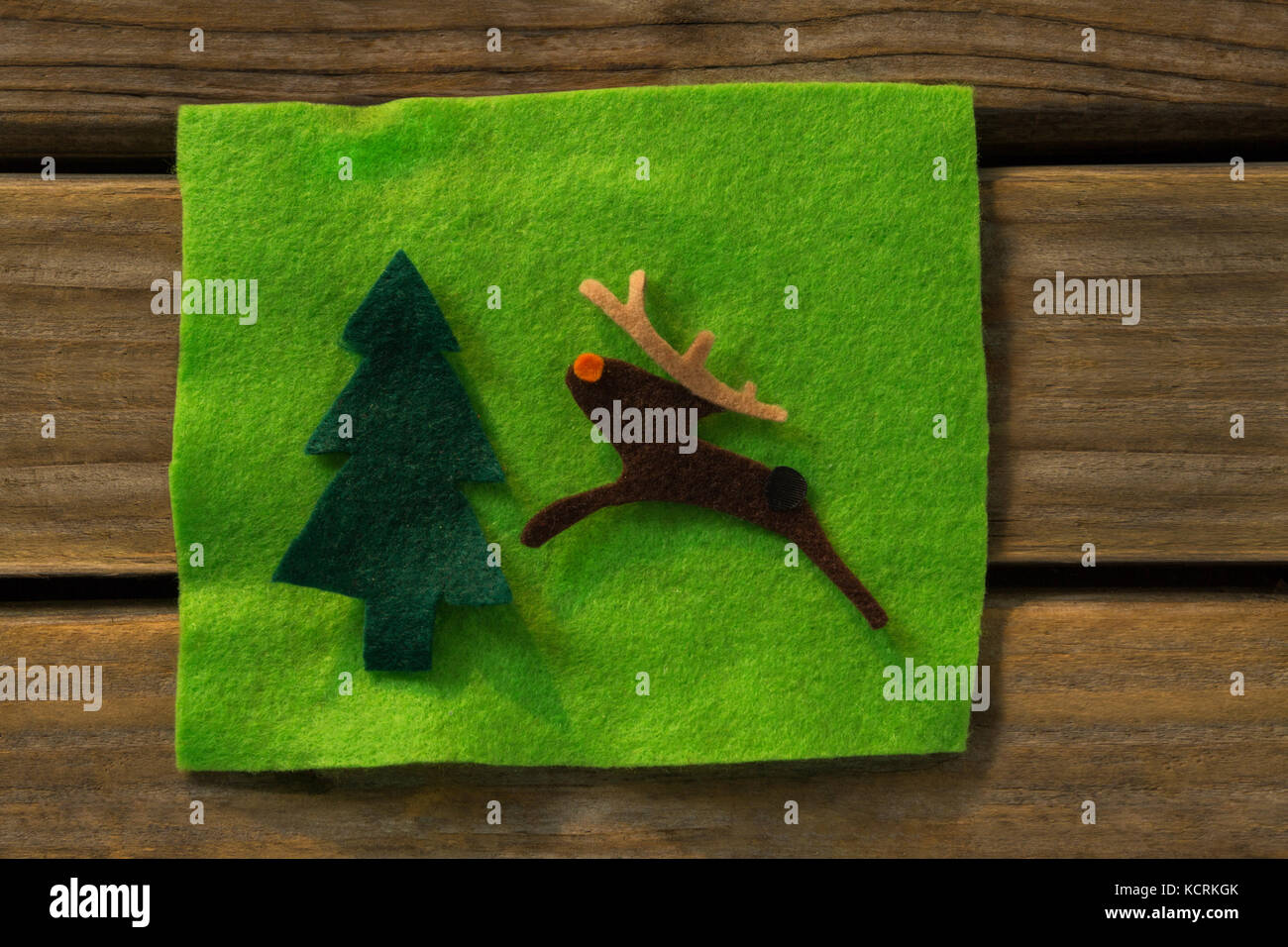 Directly above shot of Christmas tree and reindeer decoration on fabric