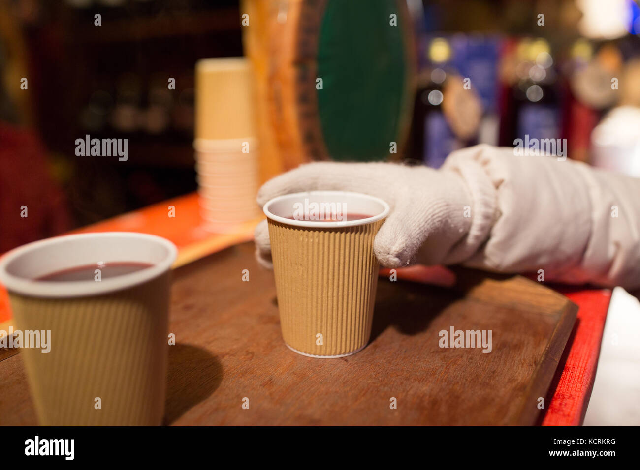 hand with cup of mulled wine at christmas market Stock Photo