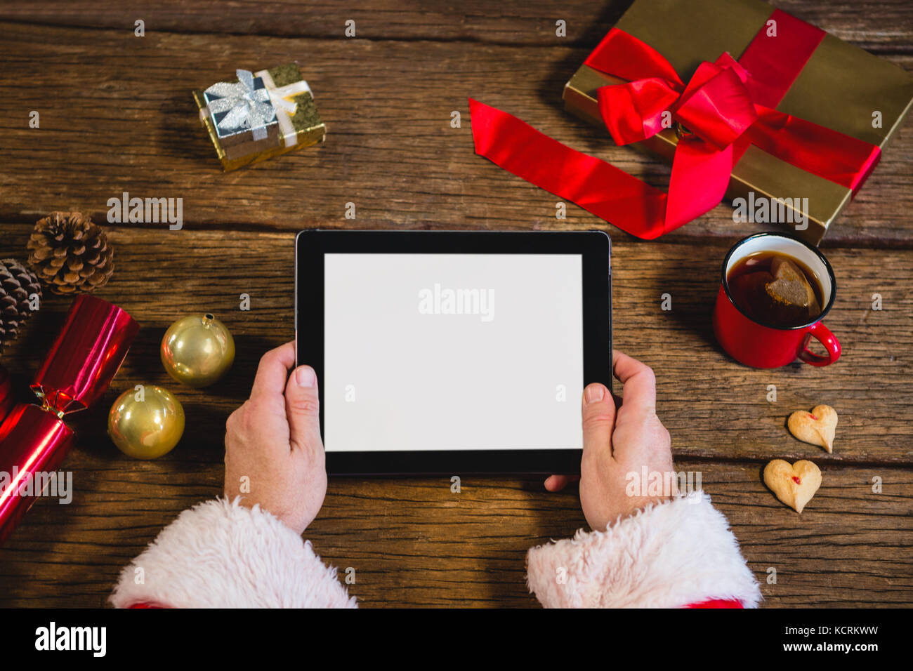 Hands of Santa Claus holding digital tablet Stock Photo
