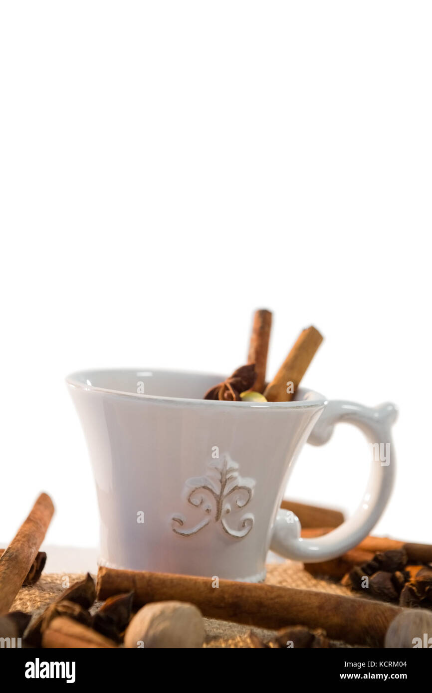 Close-up of spice tea with various ingredients against white background ...