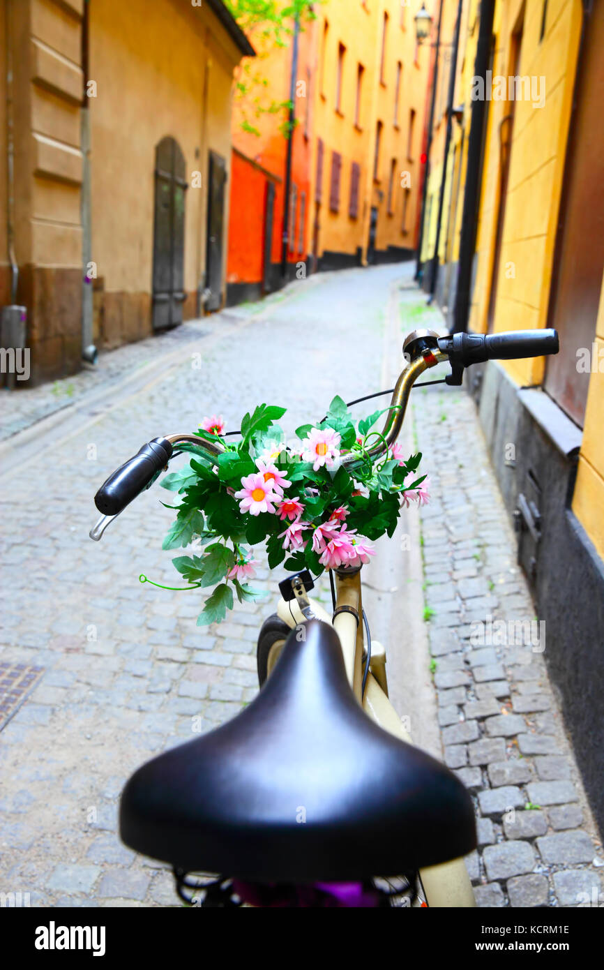 Bicycle with bunch of flowers on handle bar in Stockholm, Sweden Stock Photo