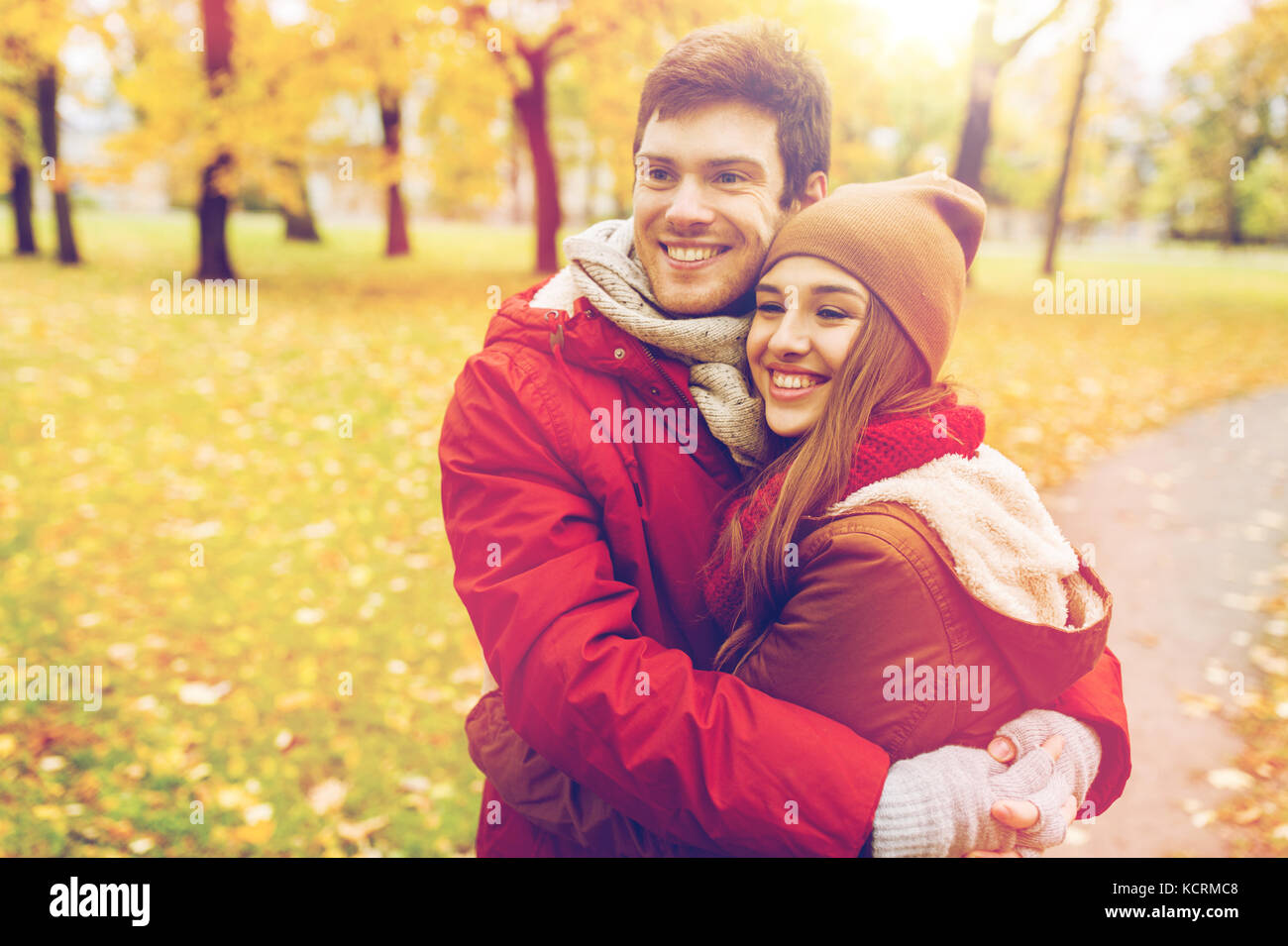 happy young couple hugging in autumn park Stock Photo - Alamy