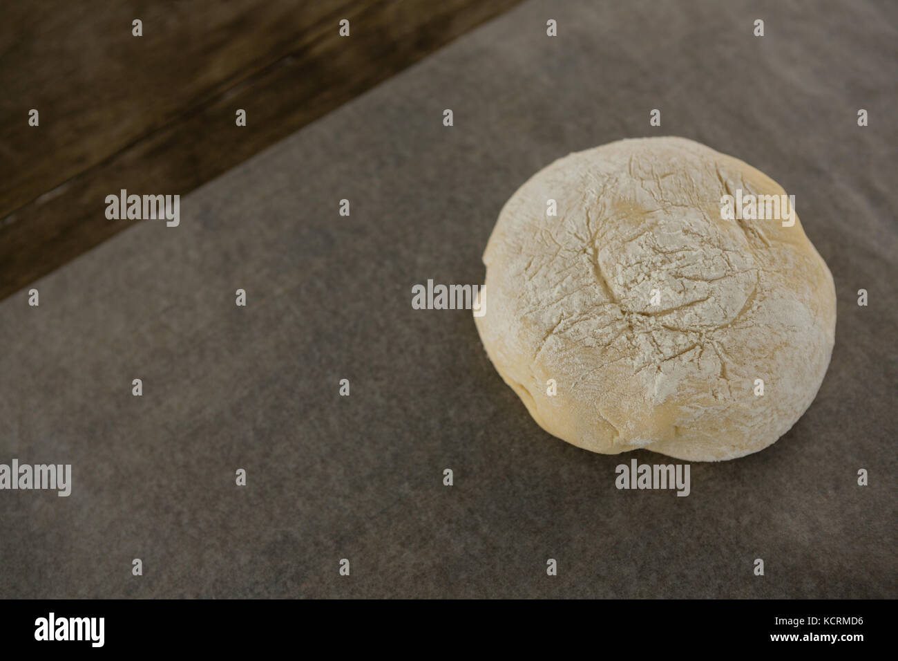 Close-up of dough ball pressed over butter paper Stock Photo