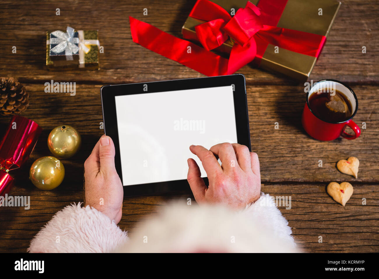 Hands of Santa Claus using digital tablet Stock Photo - Alamy