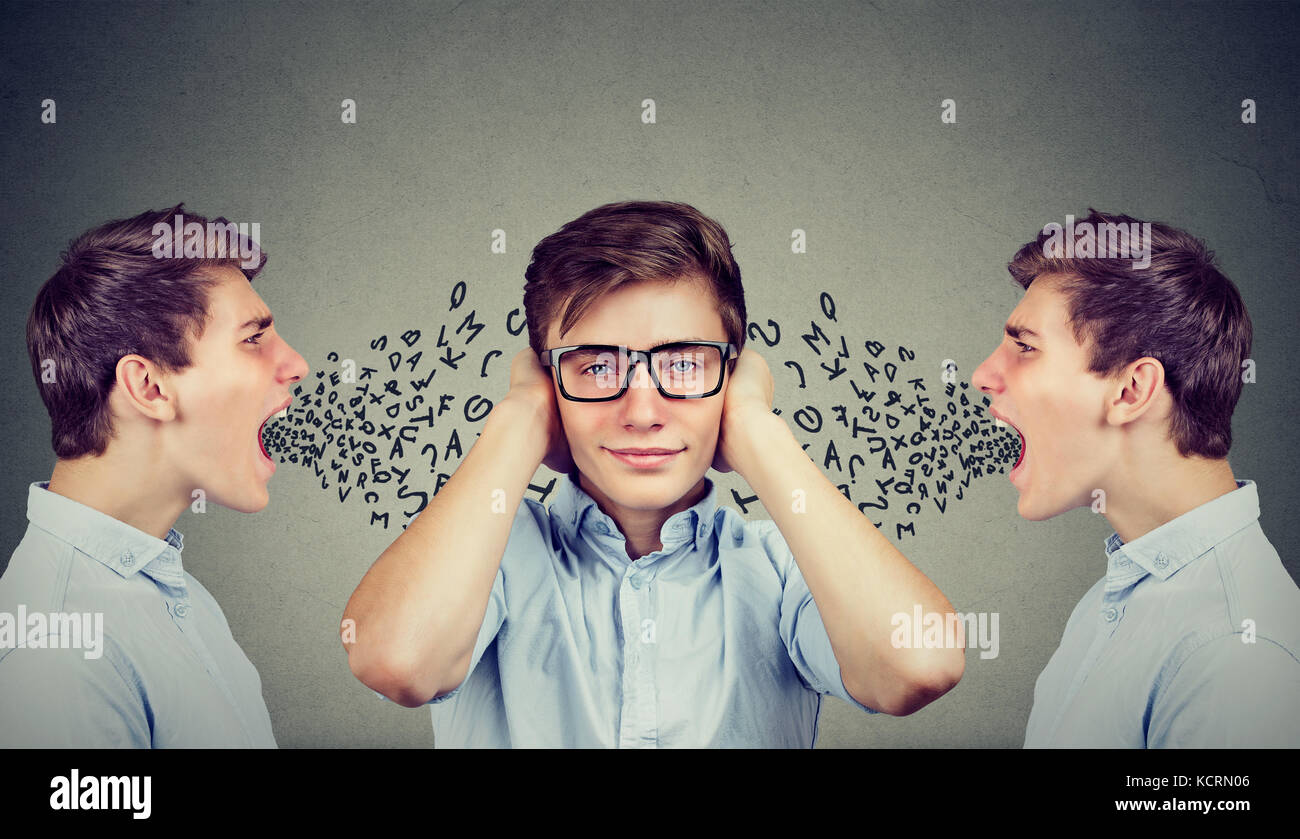 Covering his ears with hands ignoring hi-res stock photography and ...