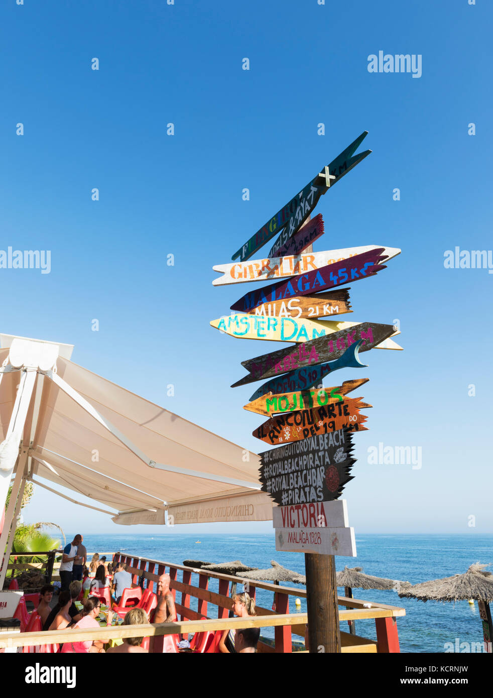 Calahonda, Mijas Costa, Costa del Sol, Malaga Province, Andalusia, southern Spain.  Signpost beside Royal Beach Pirata beach bar-restaurant on Royal B Stock Photo