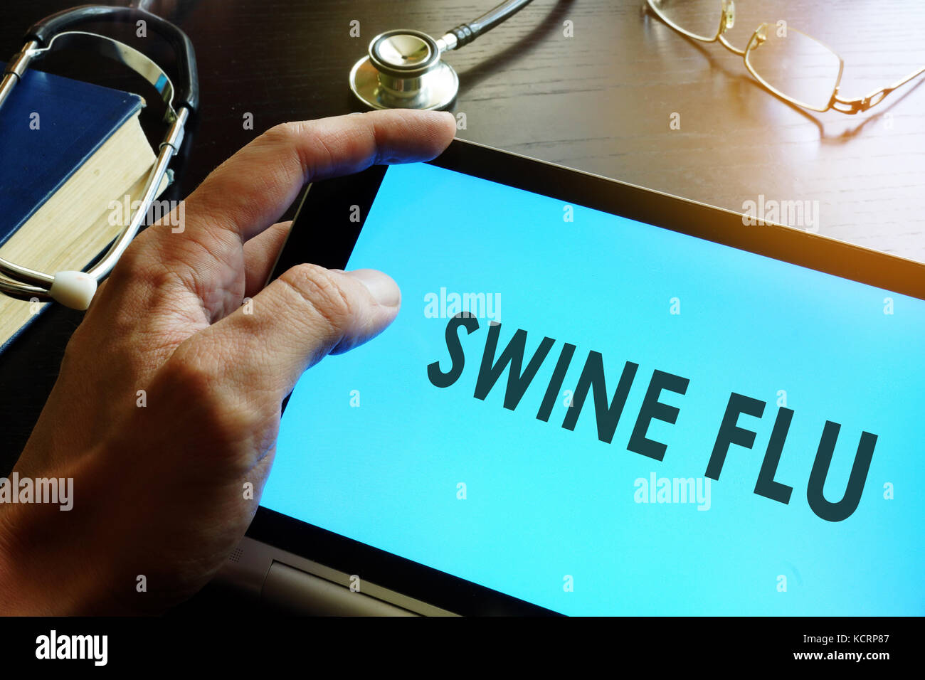 Swine Flu (Swine Influenza A (H1N1 and H3N2)) written in a tablet. Stock Photo