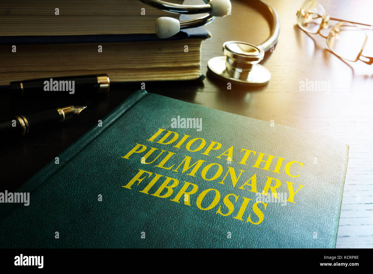 Doctor holding book about Idiopathic Pulmonary Fibrosis IPF. Stock Photo