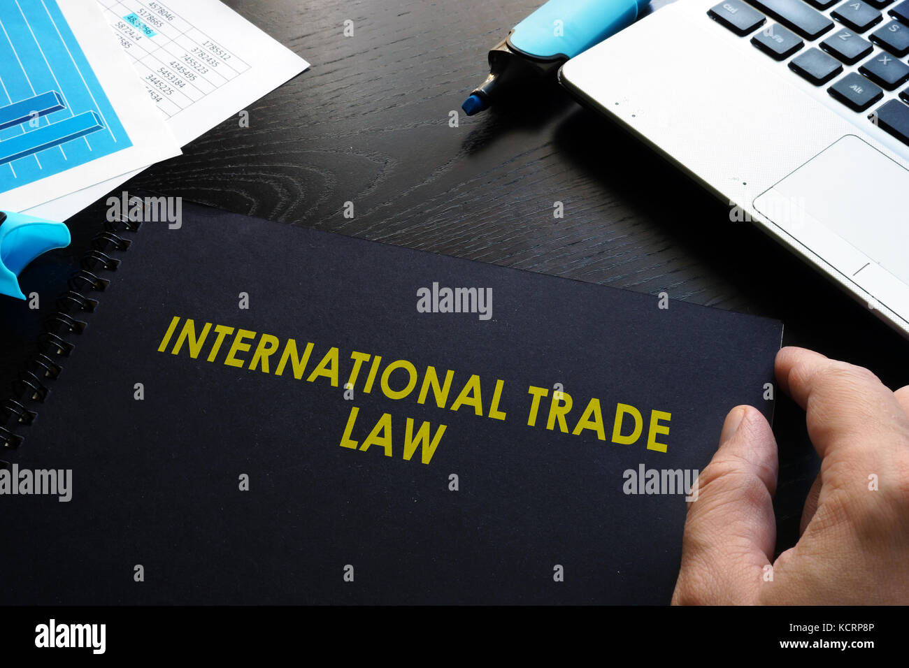 International trade law and notebook on a table. Stock Photo