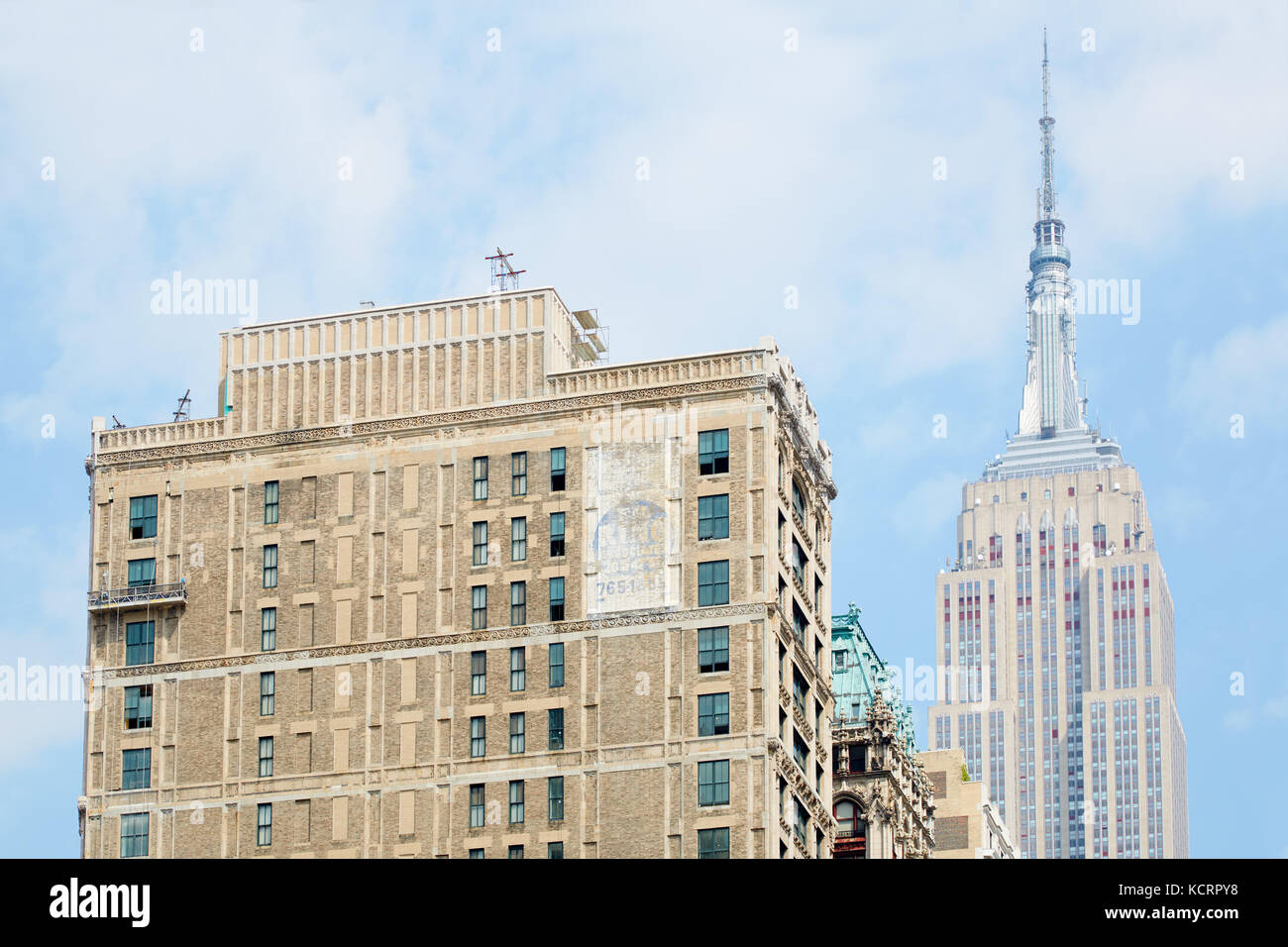 Empire State Building seen from Fifth Avenue with building in New York Stock Photo