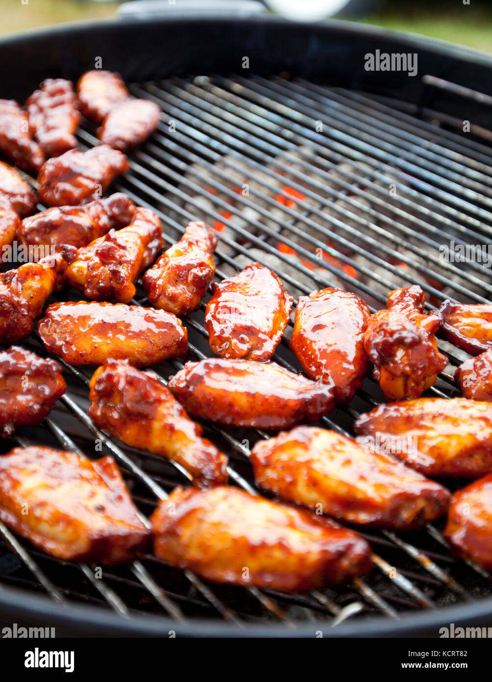 Marinated chicken wings grilling over hot charcoal Stock Photo Alamy