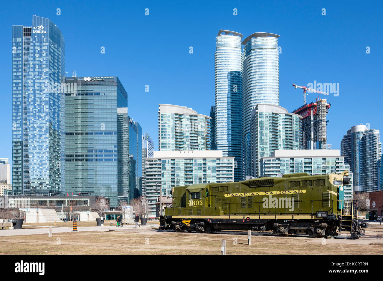 Toronto Railway Museum, Roundhouse Park, 4803 Canadian National Railway green locomotive, modern buildings in background, Toronto, Ontario, Canada. Stock Photo