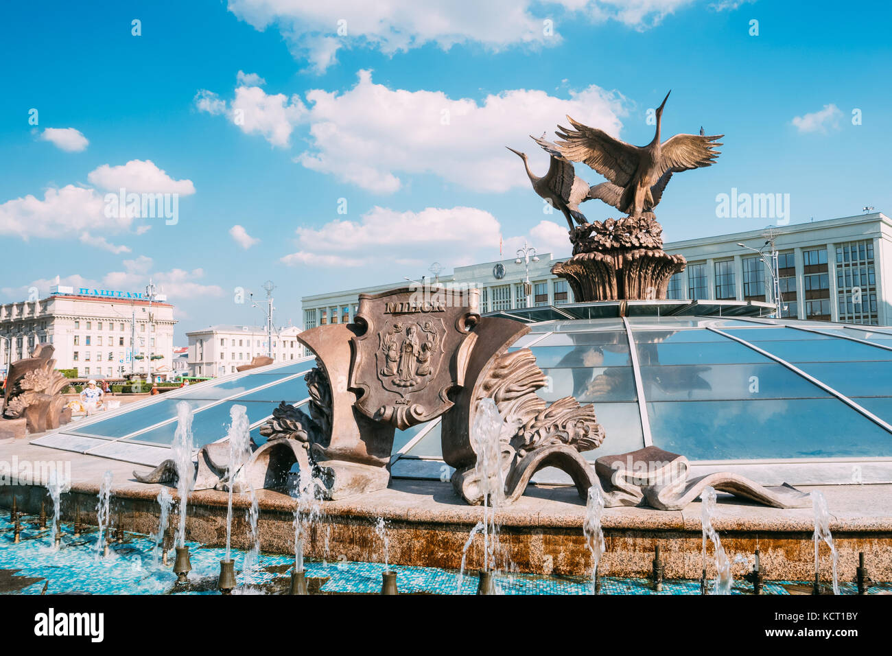 Minsk, Belarus. Bronze Sculptures Near Fountains: Coat Of Arms Of Minsk And Three Storks Cranes On Top Of Glass Dome Of Stolitsa, Underground Shopping Stock Photo