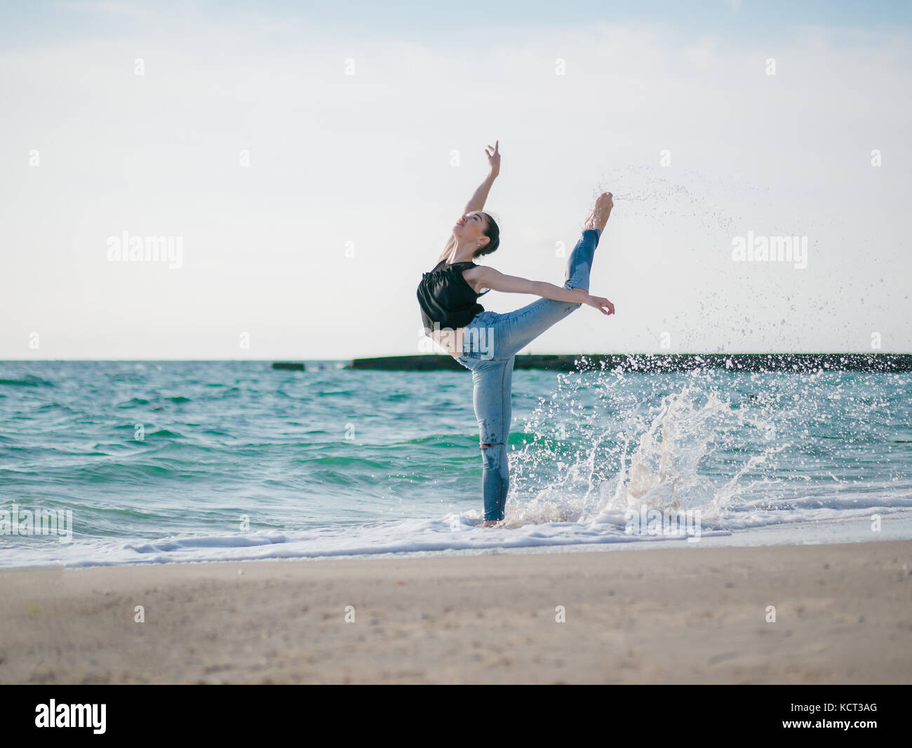 Woman dancing beach jeans hi-res stock photography and images - Alamy