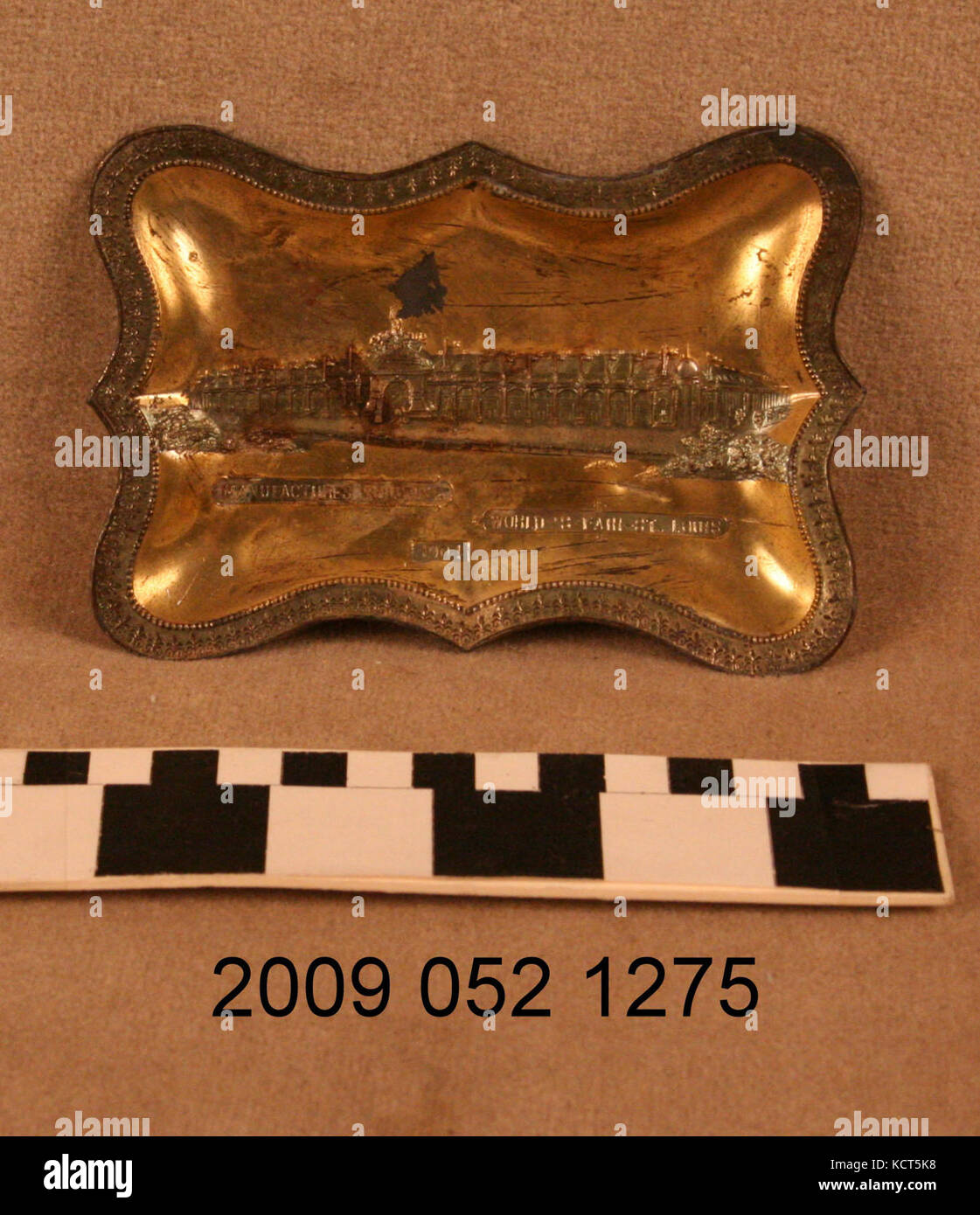 Gold Colored Pin Tray With Relief Image of the Palace of Manufactures Stock Photo