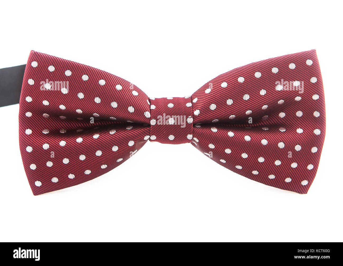 Elegant dark red bow tie with white polka dots on an isolated white ...