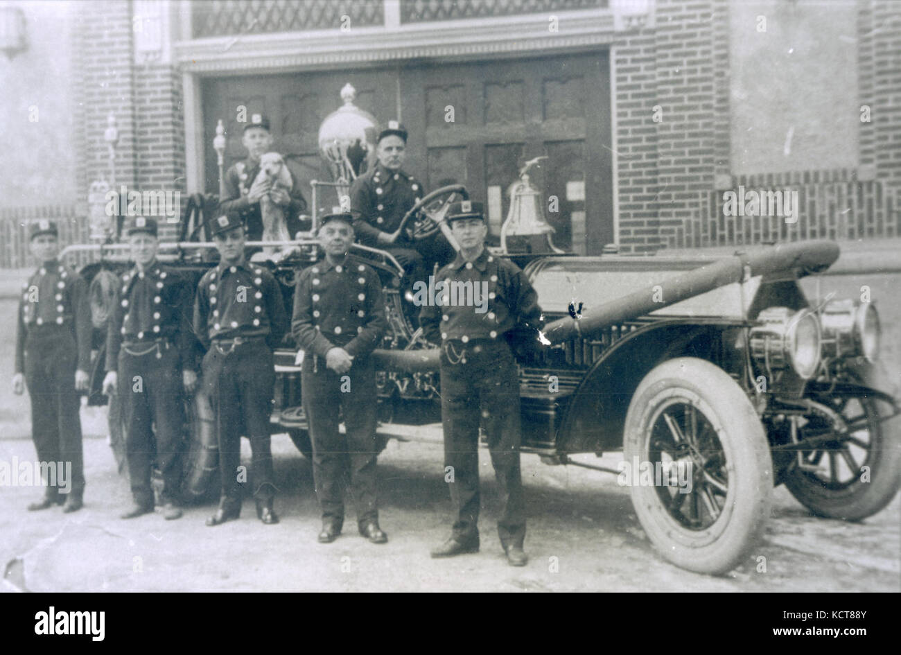 Firemen standing beside their 1910 Webb 2nd size 700 gpm combination ...