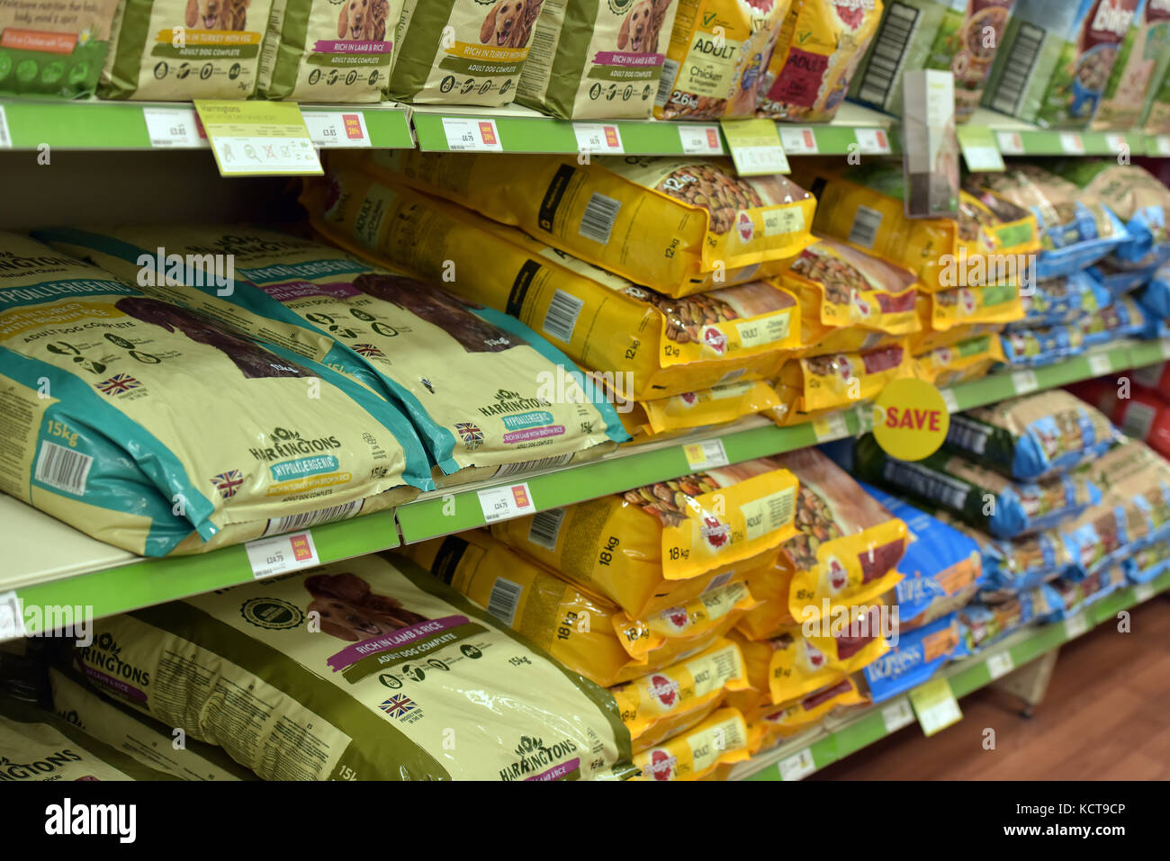 a variety of different pet food products for sale on full shelves at a