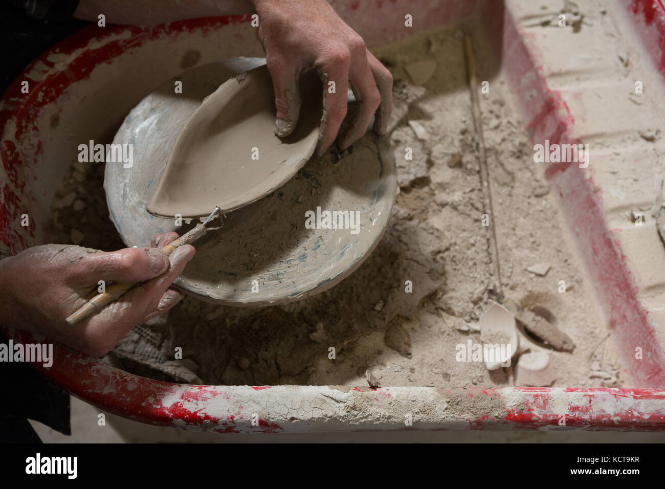 Male potters hand making a bowl Stock Photo
