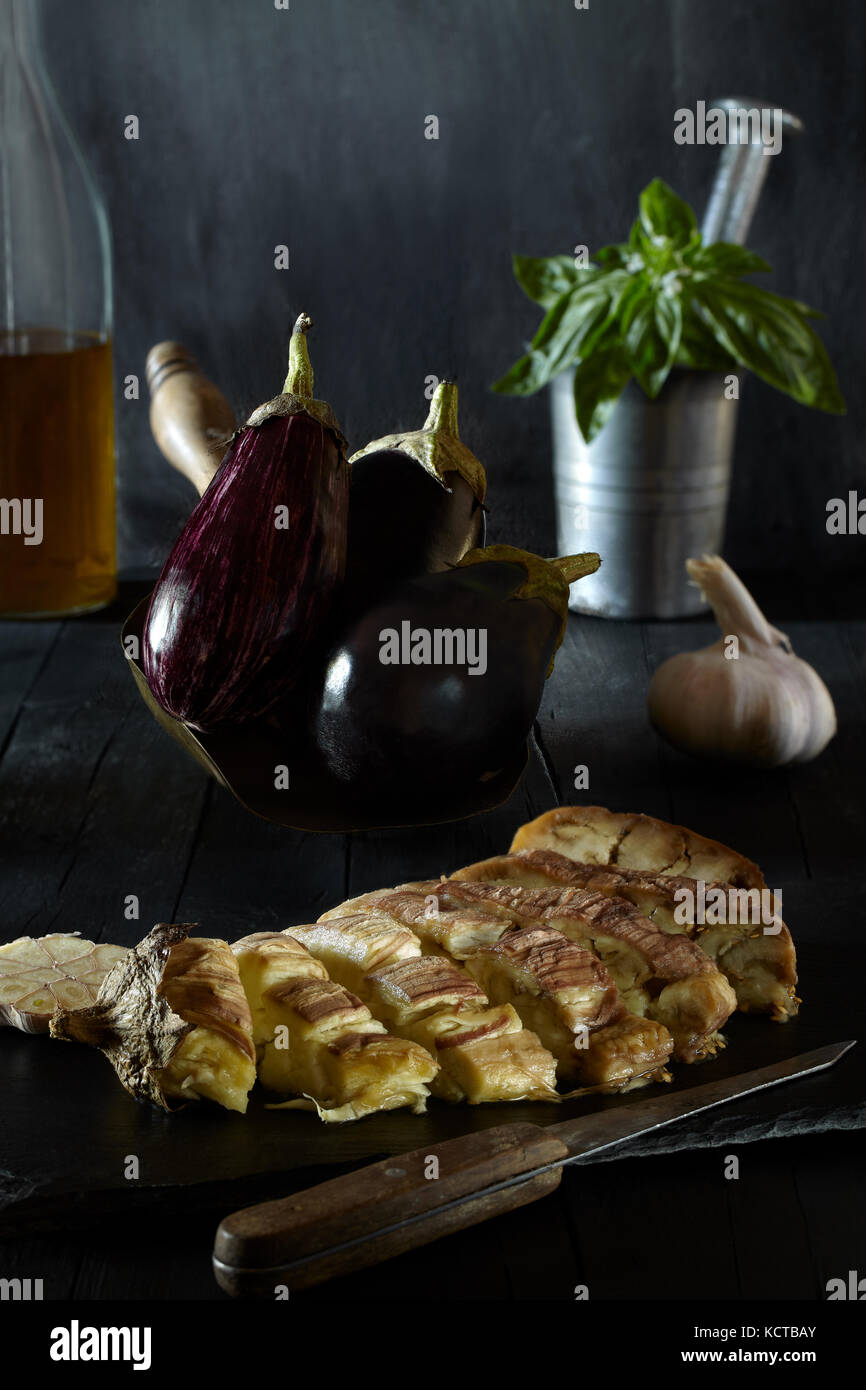 Bake eggplant on piece of slate, with raw eggplant, basil, garlic and olive oil in the