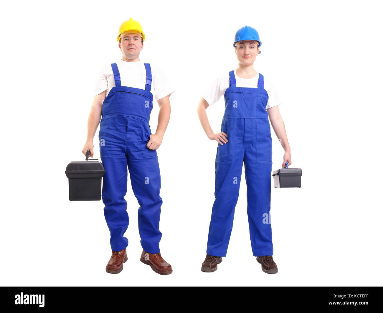 Serviceman and servicewoman wearing yellow and blue helmet and blue overall each holding black toolbox - isolated on white background Stock Photo