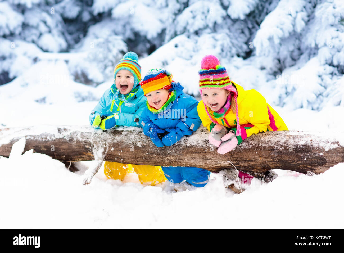 Kids playing in snow. Children play outdoors on snowy winter day. Boy ...