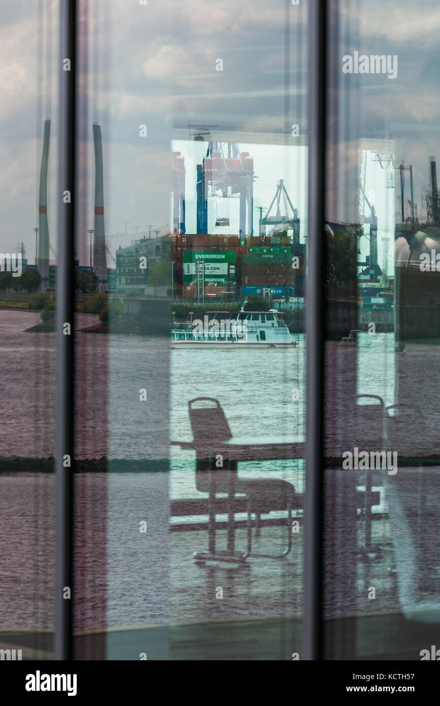 Harbour cranes at Burchardkai seen through Windows of Office building, Hamburg, Germany Stock Photo