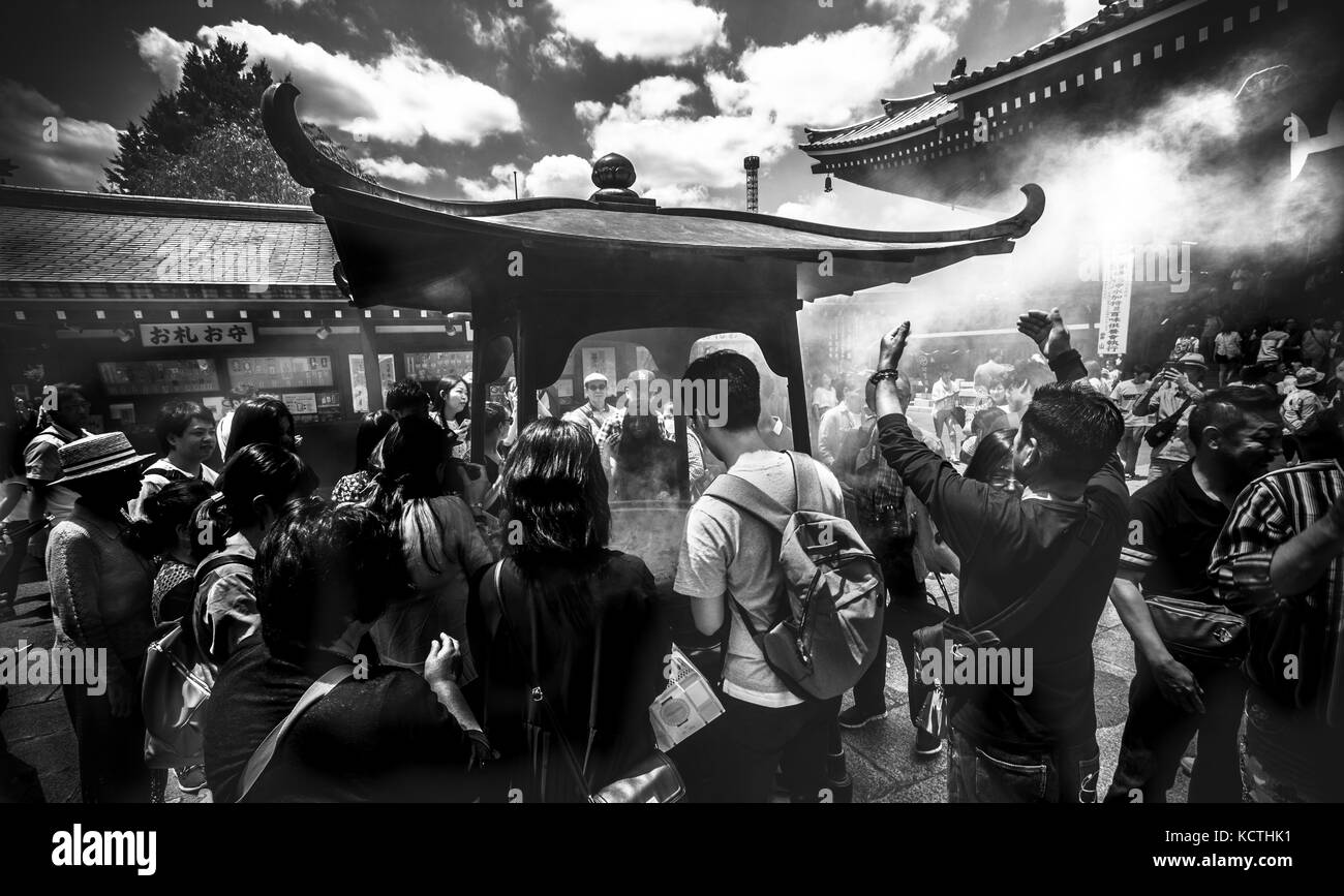 Breathing smoke in Akakusa temple, Tokyo Stock Photo