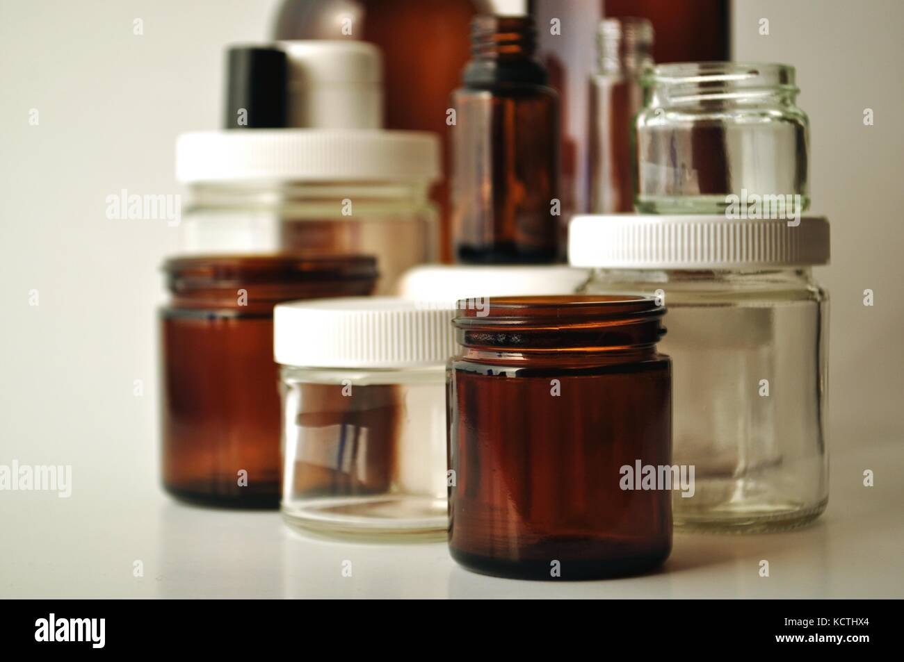 Clear and brown laboratory glass jars and bottles. Containers for
