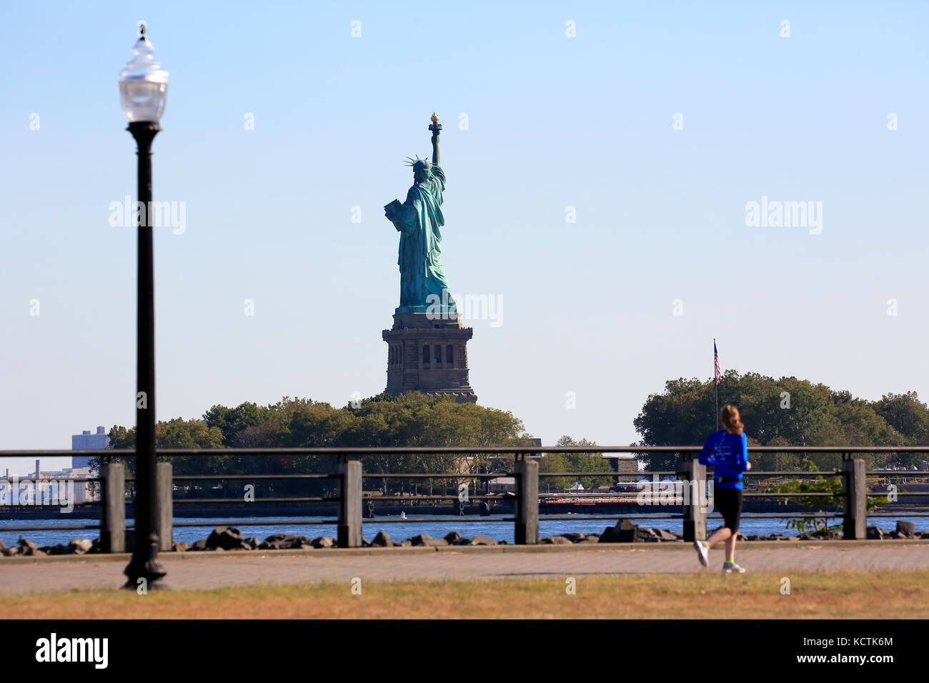 Statue of Liberty seen from Liberty State Park in New Jersey with a runner  in foreground, Jersey City.New Jersey. USA Stock Photo - Alamy