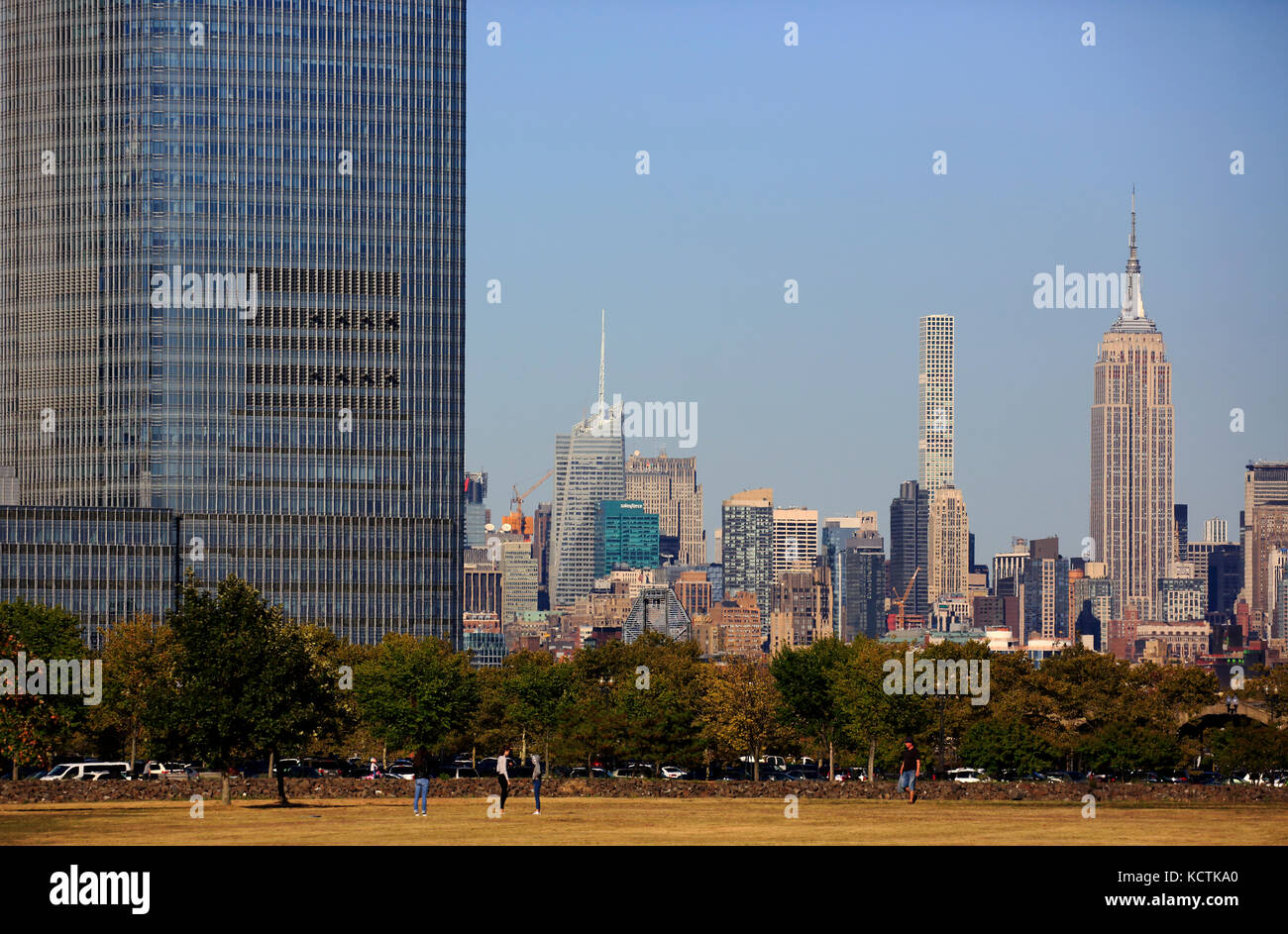 Goldman Sachs Tower in Jersey City with Empire State Building and 432 Park Avenue apartment building in background.New York City.USA Stock Photo