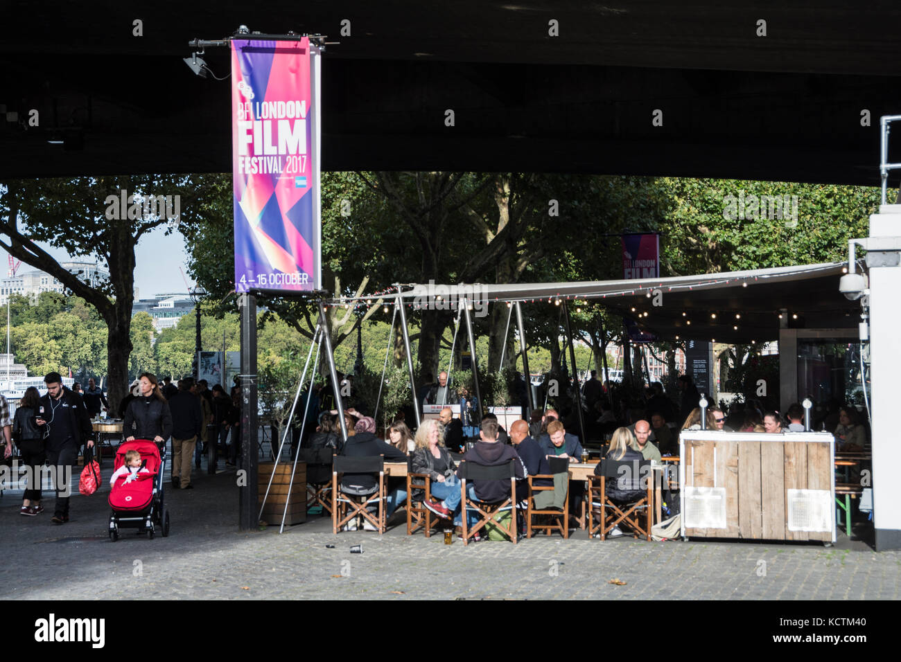 People socialising outside the British Film Institute at the National Film Theatre on London's  South Bank, UK Stock Photo